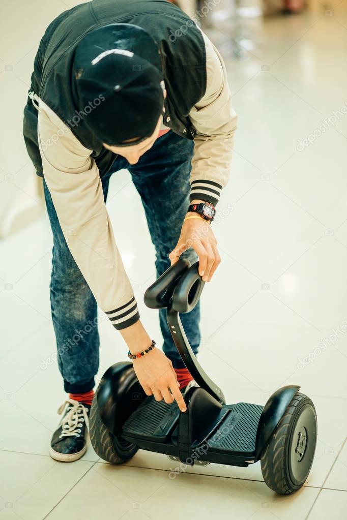man activate electric segway at mall, active man using modern transport