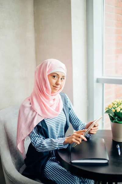 Portrait of beautiful Arabic Muslim girl using tablet — Stok Foto