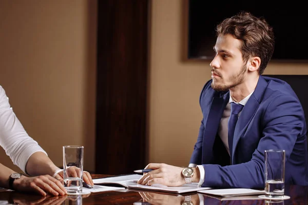 Team leader talking with coworkers in modern office