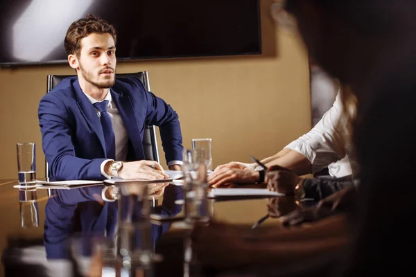 Team leader talking with coworkers in modern office