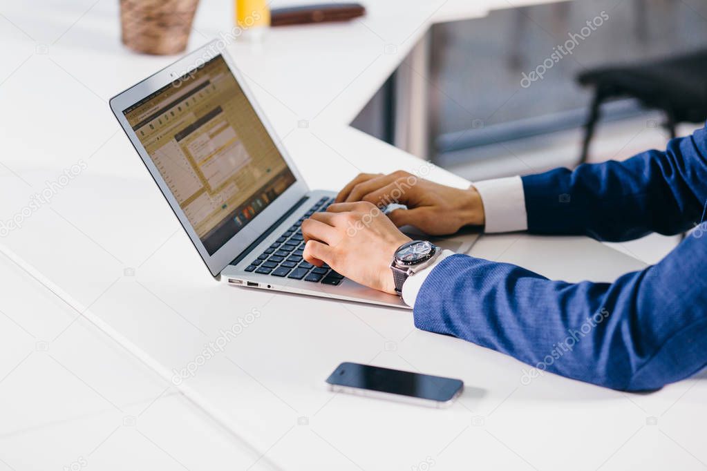 Business man or accountant working on laptop computer with business document
