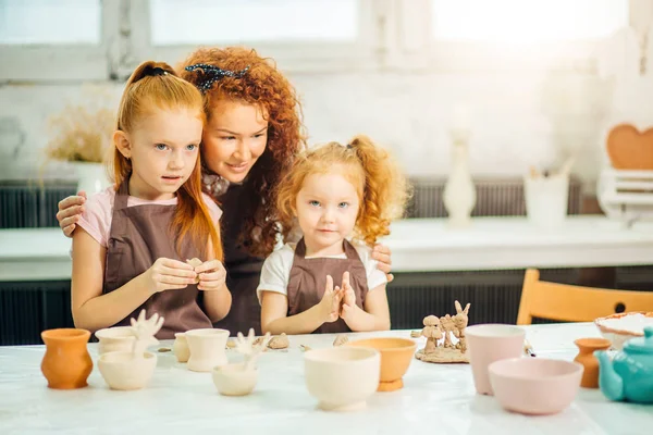 Rothaarige Mutter und kleine Tochter zu Hause aus Ton geformt und spielen zusammen — Stockfoto