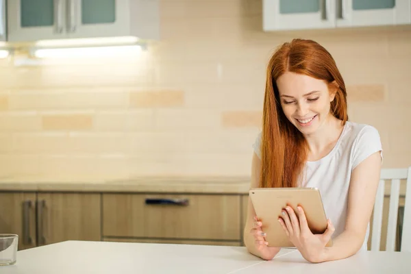 Happy smiling woman sitting with digital tablet — Stock Photo, Image