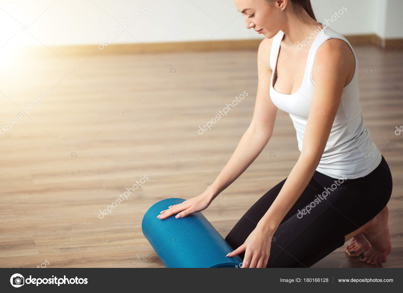 Woman Practicing Yoga Preparing For Exercise Unrolling Or