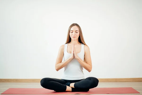 Женщина практикует йогу, сидя в Падмасане, упражнения, Lotus поза, намасте — стоковое фото