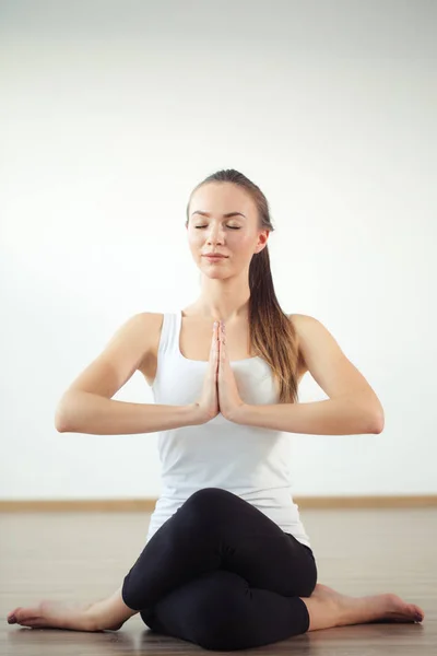 Smiling woman stretching leg on mat in gym — Stock Photo, Image