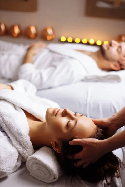 Gelukkige jonge mooie paar genieten van hoofd massage in de spa — Stockfoto