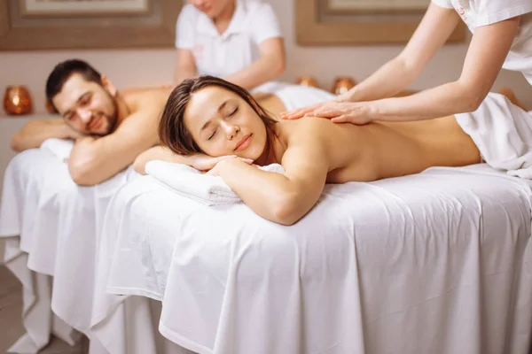 Happy couple getting massage at spa — Stock Photo, Image