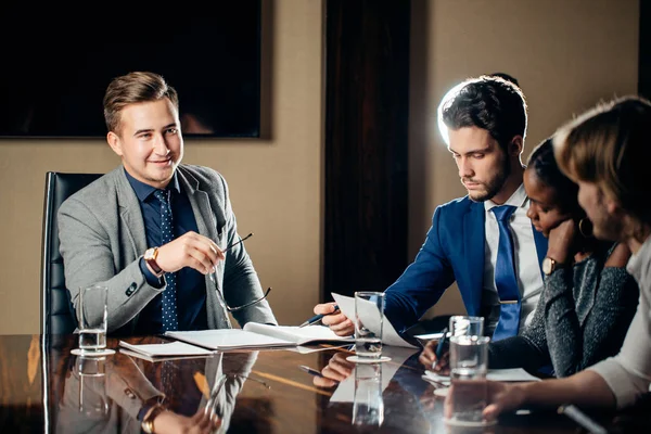 Team leader talking with coworkers in modern office