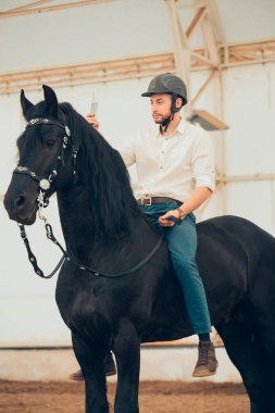 üzerinde kahverengi bir binicilik tişörtlü adam