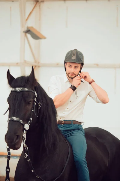 Man in a shirt riding on a brown horse — Stock Photo, Image