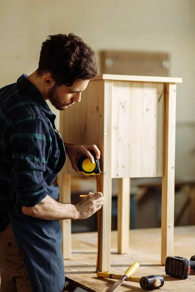 Carpenter working in his woodwork or workshop — Stock Photo, Image