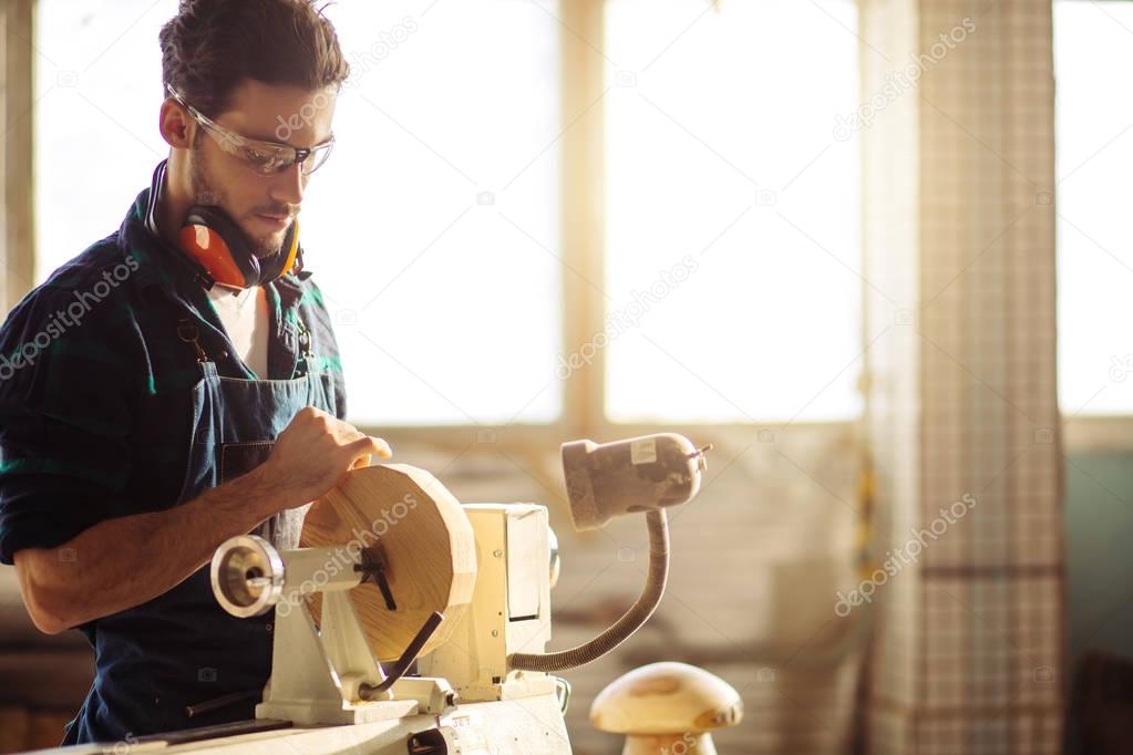 attractive man begin doing woodwork in carpentry