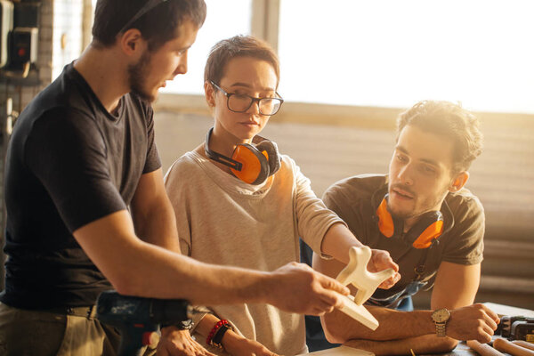 Carpenter Training Female Apprentice To Use Plane