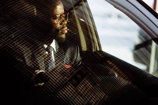 Schöner afrikanischer eleganter ernsthafter Mann fährt Auto — Stockfoto