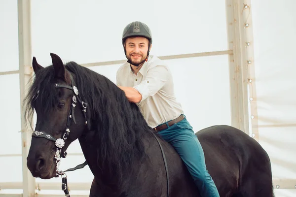 Man in a shirt riding on a brown horse — Stock Photo, Image