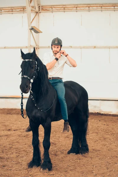 Man in a shirt riding on a brown horse — Stock Photo, Image