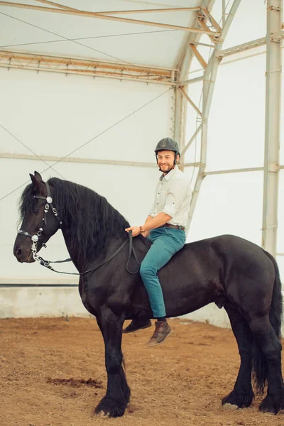 Man in a shirt riding on a brown horse — Stock Photo, Image