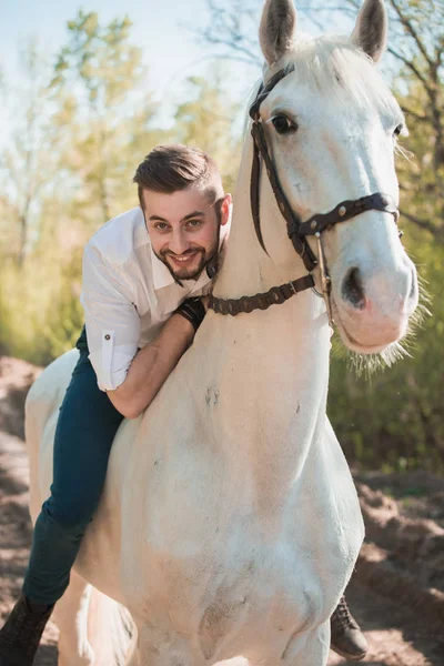 Man in a shirt riding on a brown horse — Stock Photo, Image
