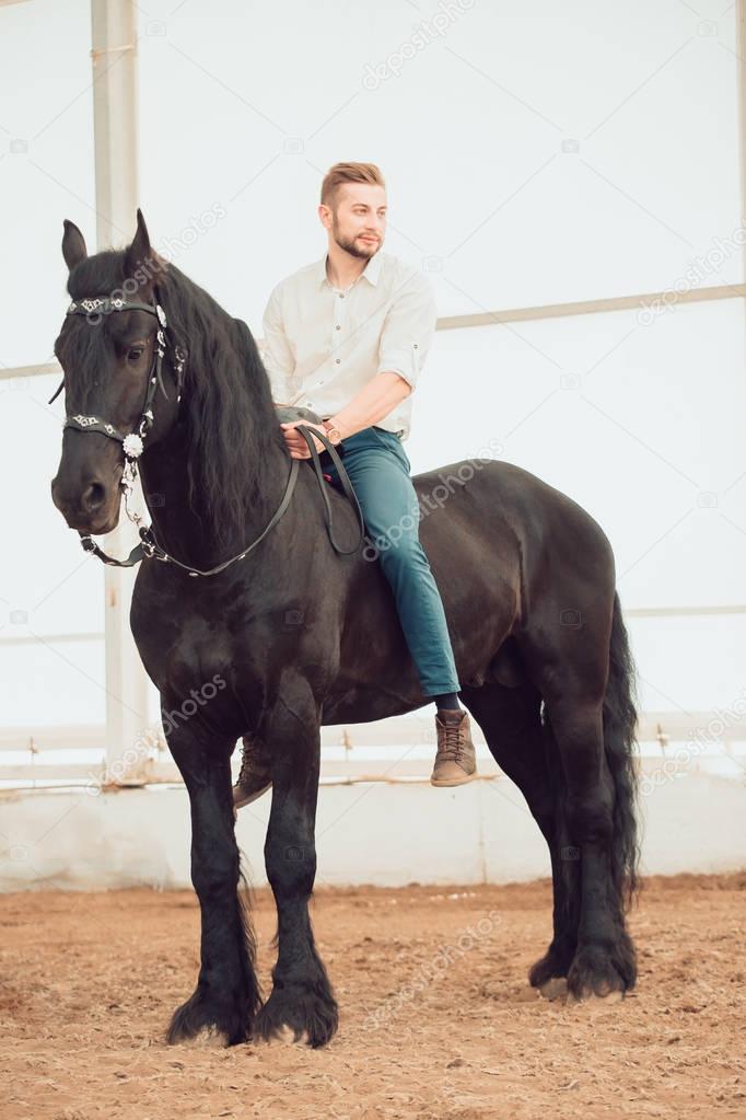 man in a shirt riding on a brown horse