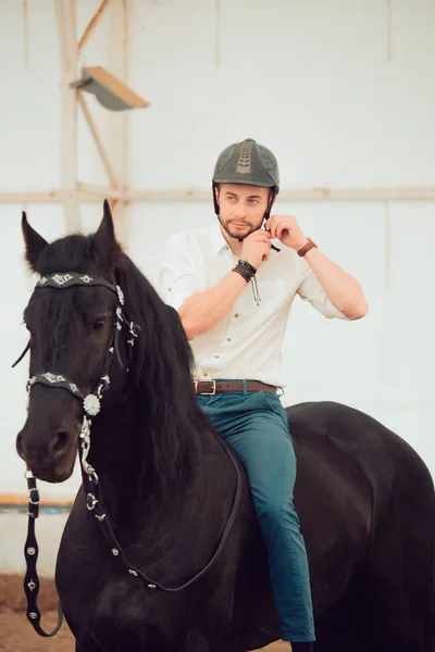 Man in a shirt riding on a brown horse — Stock Photo, Image