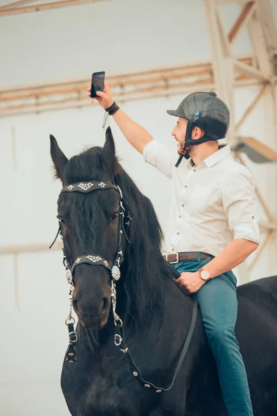 Man in a shirt riding on a brown horse — Stock Photo, Image