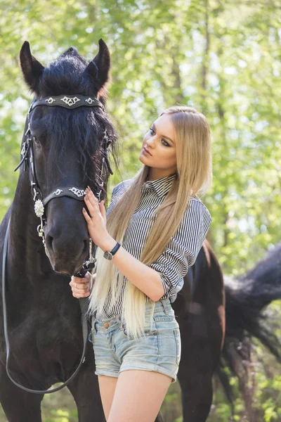 Beautiful girl stroking horse outside — Stock Photo, Image