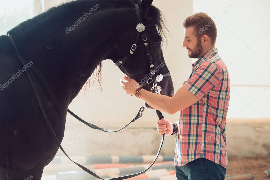 Young man with horse. Autumn outdoors scene