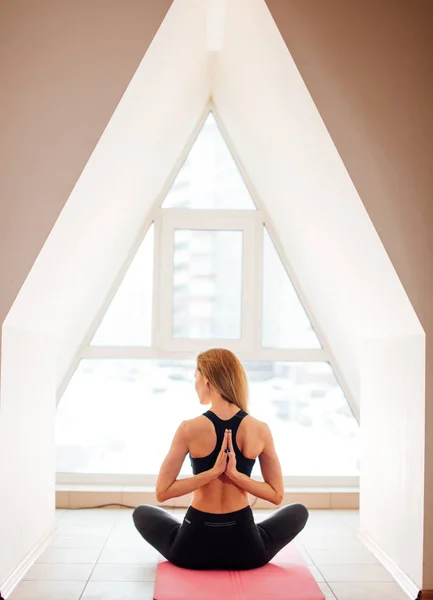 woman doing yoga in reverse prayer pose. Pashchima Namaskarasana