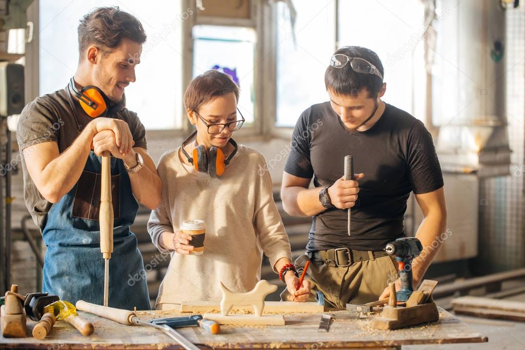 Carpenter Training Female Apprentice To Use Plane