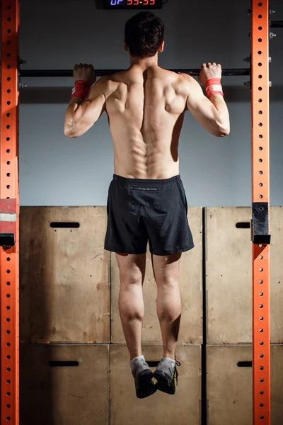 Fitness tenen te bar man pull-ups bars training oefenen op sportschool — Stockfoto