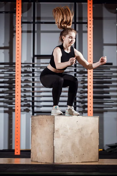 Fitness nő jumping box edzés az edzőteremben, a kereszt illeszkedik gyakorlása — Stock Fotó