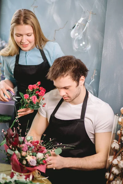 two people making money in flower business