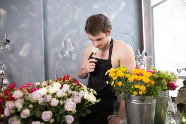 brutal shop assistant holding rose and thinking about his girlfriend in studio