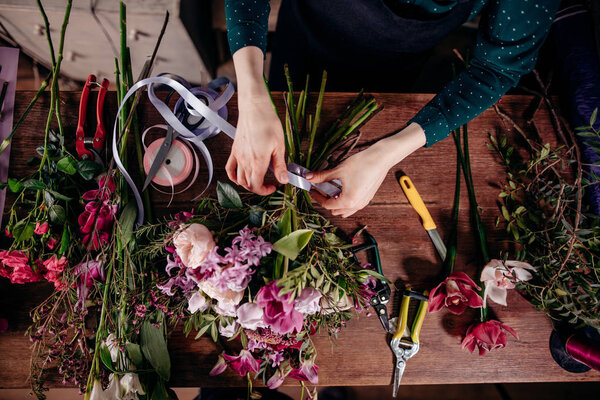 photo of woman adding roses together
