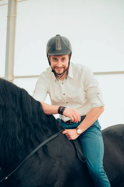 Man in a shirt riding on a brown horse — Stock Photo, Image