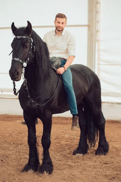 Man in a shirt riding on a brown horse — Stock Photo, Image