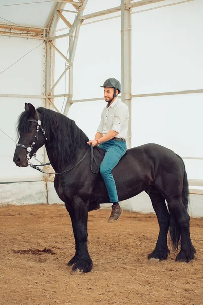 Man in a shirt riding on a brown horse — Stock Photo, Image