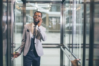 afroamerican işadamı telefonda konuşurken modern Cam Asansör