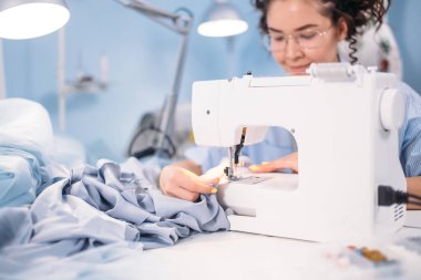 dikiş makinesi tasarım Studio üzerinde dikmek öğrenme kadın görüntüsünü kırpılmış