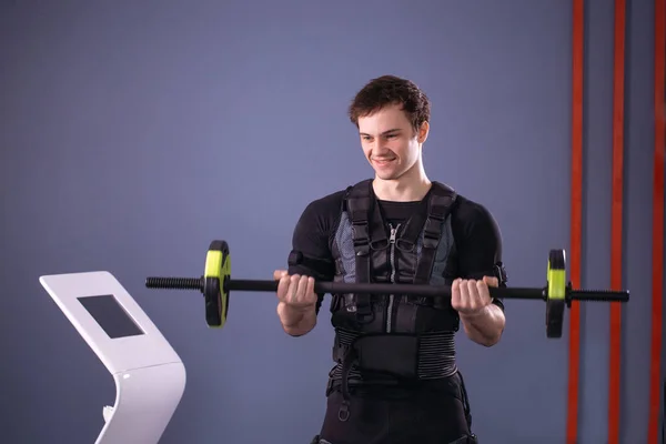 Man working out EMS training with barbell closeup, power pose — Stock Photo, Image