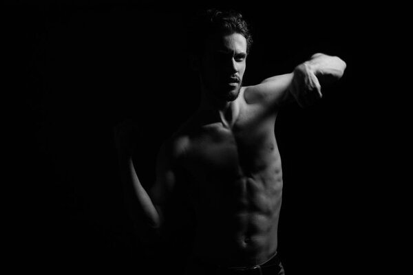 white and black image of young man with wonderful physique