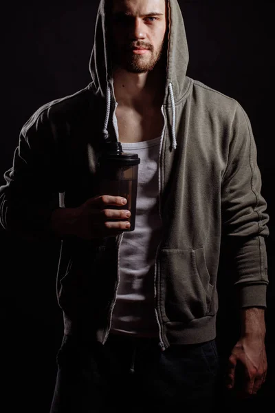 Cropped portrait of Caucasian hood man standing with thermos. a sip of hot tea. — Stock Photo, Image