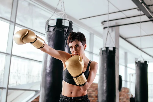confident female boxer is preparing for boxing match