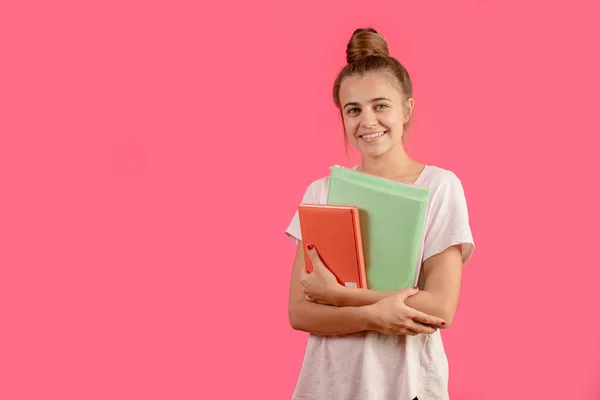 Sonriente joven hembra posando con libro y carpeta — Foto de Stock