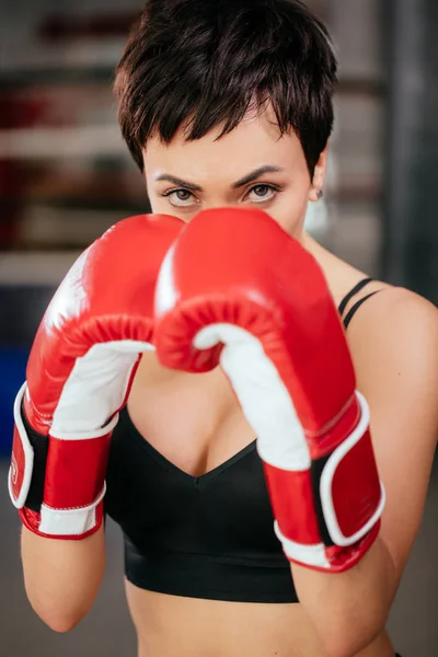 Bossy woman closed her face with red boxing gloves. protection.self-defense — Stock Photo, Image