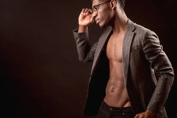 Модель из Африки с обнаженным туловищем и пиджаком в очках — стоковое фото