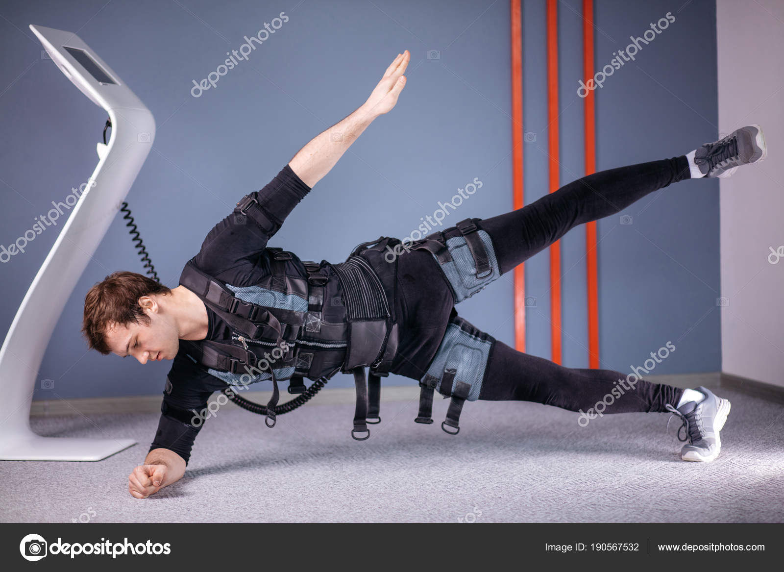 Man in Electrical Muscular Stimulation suits doing side plank exercise