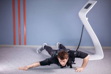 Ems erkek itme yapıyor ups içinde elektrik kas Stimülatörü bağlıyken jimnastik salonu