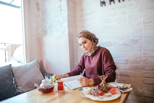 Muslimská žena pracující v kavárně — Stock fotografie